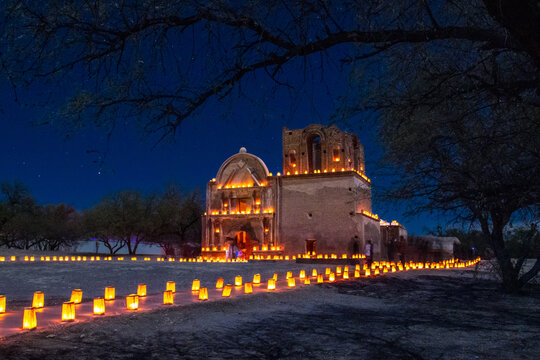 Christmas Magic at Mission San Jos&eacute; de Tumac&aacute;cori shows the Christmas Eve luminaria lighting on the mission.