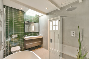 Modern bathroom with green tile and elegant fixtures