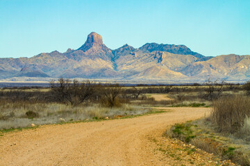 A dirt road crosses the sonoran desert heading toward Baboquivari mountains in southern Arizona...