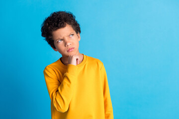 Portrait of cute small schoolkid look empty space wear pullover isolated on blue color background