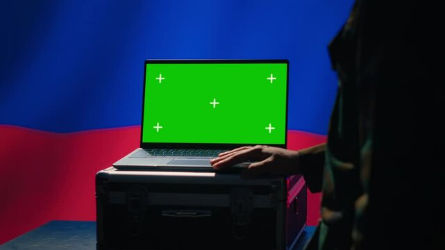 Russian soldier using military tech on green screen laptop to identify threats from enemies. Russia ex KGB FSB personnel using software on mockup notebook to relay info to war front lines, camera A