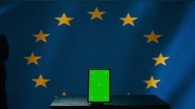 European Union counterintelligence division uses green screen tablet to protect against propaganda affecting elections. EU security service safeguarding democracy online using mockup device, camera B