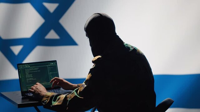 Israel secret police agent uses mass propaganda tools on laptop to influence population minds, engaging in psychological operations. Mossad Israeli spy commits PsyOp sabotage using device, camera A