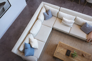Top view of modern living room with cozy sectional sofa and wooden coffee table, copy space