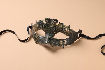 One beautiful carnival mask on beige background