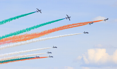 The Frecce Tricolori, Italy's celebrated aerobatic team flying on the blue sky background