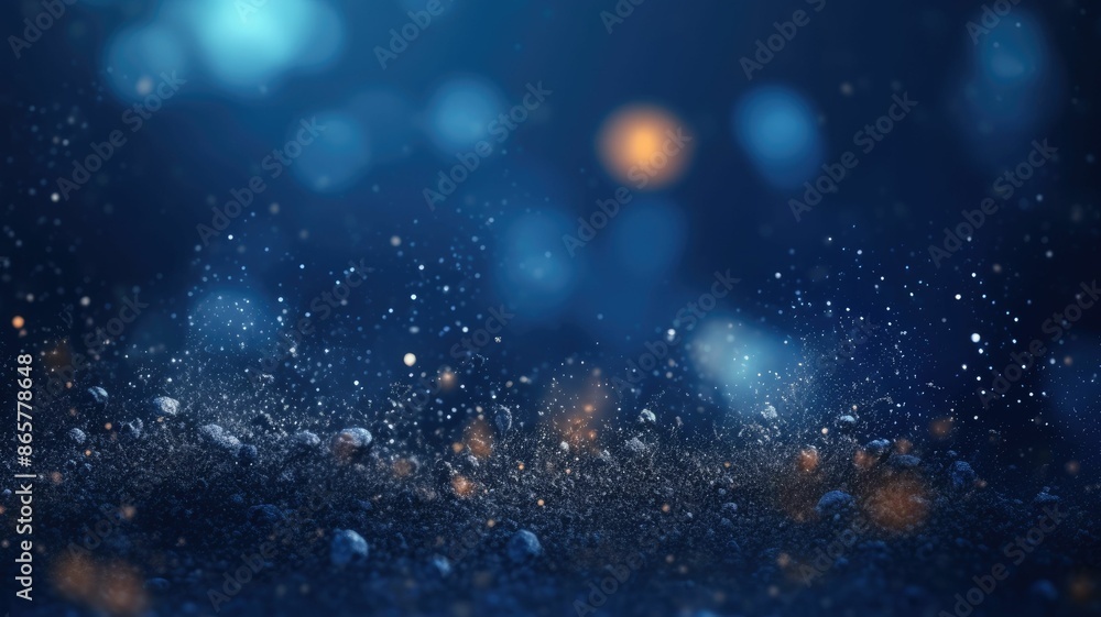 Poster bokeh lights on a gradient blue background. numerous sparkly gold particles of various sizes scatter
