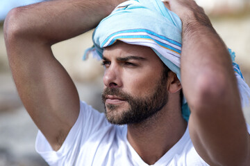 Man, Arab and thinking in outdoor nature, scarf and serious muslim on vacation in Dubai. Male...