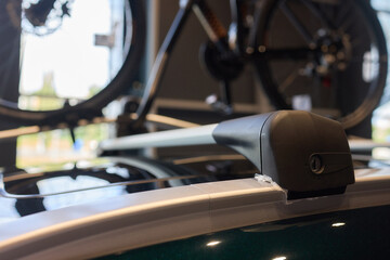A Image Showing a Bicycle Mounted on a Cars Roof Rack in a Sunlit Automobile Showroom