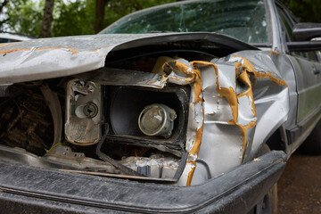 An accident in a parking lot resulted in frontend damage to a car due to a collision