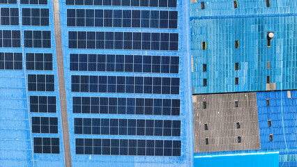 top view of grid of technology renewable solar energy. construction solar panels system on roof. Installing solar photovoltaic panel system. background of blue of solar cell system and structure roof.