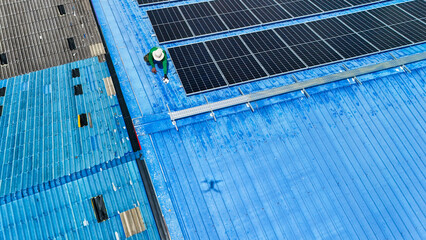 Worker Technicians are working to construct solar panels system on roof. Installing solar photovoltaic panel system. Men technicians walking on roof structure to check photovoltaic solar modules.