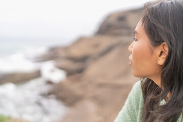 Latin beauty woman gazing the ocean from viewpoint