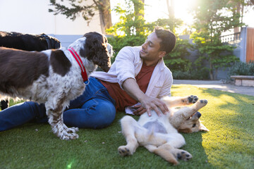 Playing with dogs in backyard, man enjoying quality time with pets