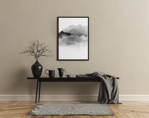 Black Framed Poster of Linear Minimalistic Mountain and Cloud Landscape on Beige Wall Above Console Table with Dark Vases, Grey Blanket.