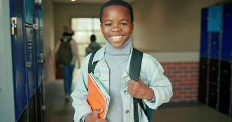 Smile, child and portrait of boy at locker for education, growth or development at elementary school. Campus, face and happy student with backpack, study books and confidence in hallway for learning