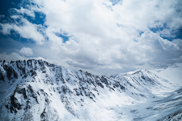 Panorama of mountains on snow peaks. The mountains are as vast as the eye can see.