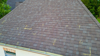 Roof with hail damage and marking from hail insurance inspection © Chad Robertson