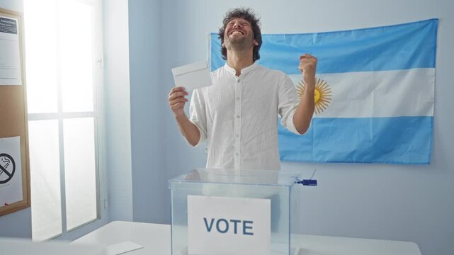 Young hispanic man holding vote celebrates victory at the argentinian electoral college, proudly raising arms in excitement and success