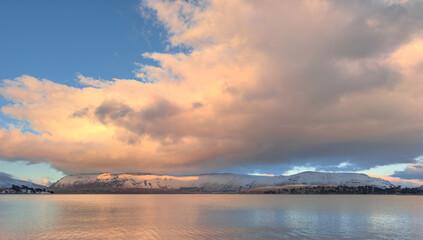 Sunset over Lake Caviahue with snow capped mountains in the background, Patagonia Argentina