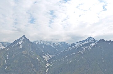 Leh Mountain Peaks Shrouded in Clouds under Clear Blue Sky