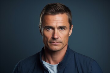 Obraz premium Portrait of a handsome mature man over blue background. Men's beauty, fashion.