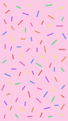 Colorful sprinkles scattered on a pink background
