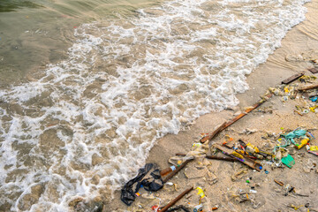 Trash, plastic cups and plastic bags at the beach. environmental problem concept and healing the world	