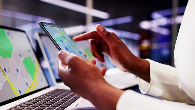 African woman using smartphone to search for property listings
