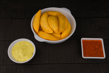 Colombian empanada with spicy sauce 