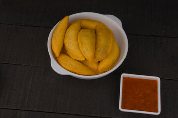 Delicious traditional Colombian empanadas with spicy sauce