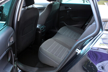 Modern car rear seats made of gray textile. Rear row of passenger car seats. Clean car interior....
