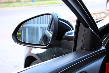 Fototapeta premium Car mirror with rear view reflection. Side rear-view mirror on a car. 