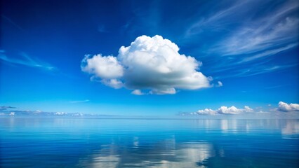 Obraz premium Serene and tranquil atmosphere depicted by a lone white cloud drifting lazily across a vibrant Azure blue sky background