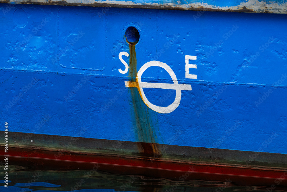 Wall mural Plimsol mark on the side of a blue ferry.