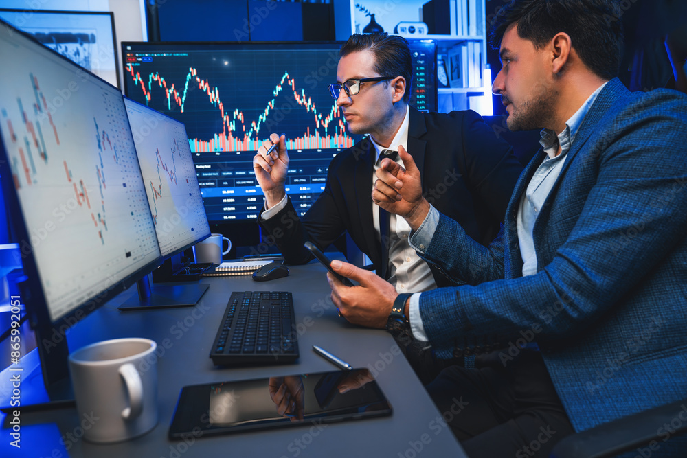 Aufkleber two stock exchange traders discussing dynamic investment graph in currency rate on monitor at night.
