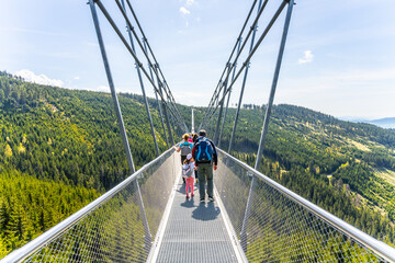 The Sky Bridge 721 is the worlds longest suspension footbridge in Dolni Morava Resort, Czechia. Visitors enjoy scenic forest views as they walk.