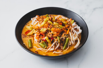 plant-based dan dan rice noodles soup with mixed vegetables and spicy sauce