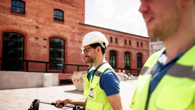Smiling electrician and plumber with toolboxes arriving at the restaurant