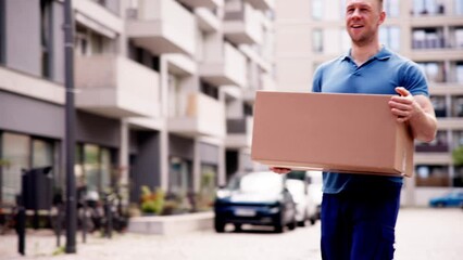 Courier's Mishap: A Young Caucasian Delivery Man Holding a Falling Box