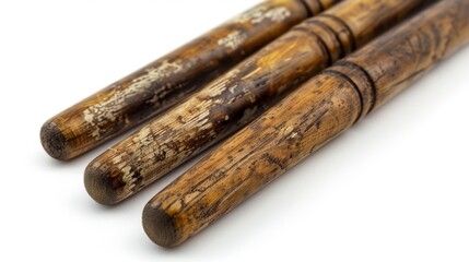 A set of drumsticks with a worn texture, against a white background.