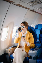 Asian Woman Working on Tablet During  in first class, multitasking with Flight Travel in style, work