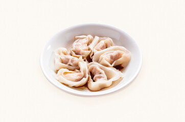Dumplings, Wontons, Shao Mai, Shrimp and Pork Wontons with Soy Sauce served in plate isolated on grey background side view of hong kong food