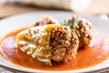 Stuffed green pepper with meat balls in tomato sauce, sourdough dumpling in the background