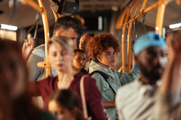 Teenage girl with curly hair standing on a bus