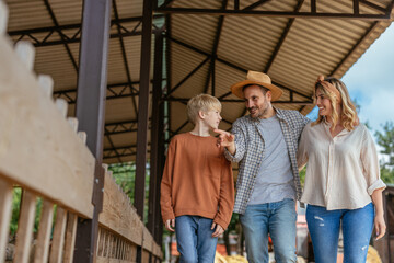 Family of three visiting a farm