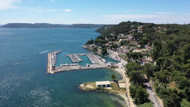Aerial view drone video flying from the air over the picturesque sea coast of the south of France, Provence, Istres at bright sunny summer day