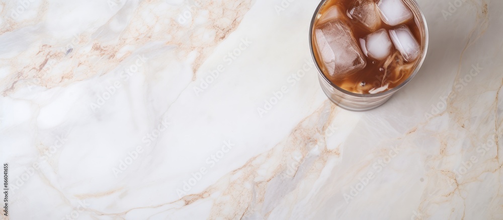 Aufkleber Marble surface with a clear glass of iced cocoa offering copy space image.