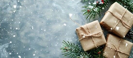 Gift boxes wrapped in kraft paper, adorned with spruce branches, set against a snowy backdrop, providing a festive copy space image.