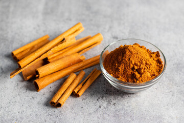 selective focus of raw cinnamon with powder. healthy herbs.  